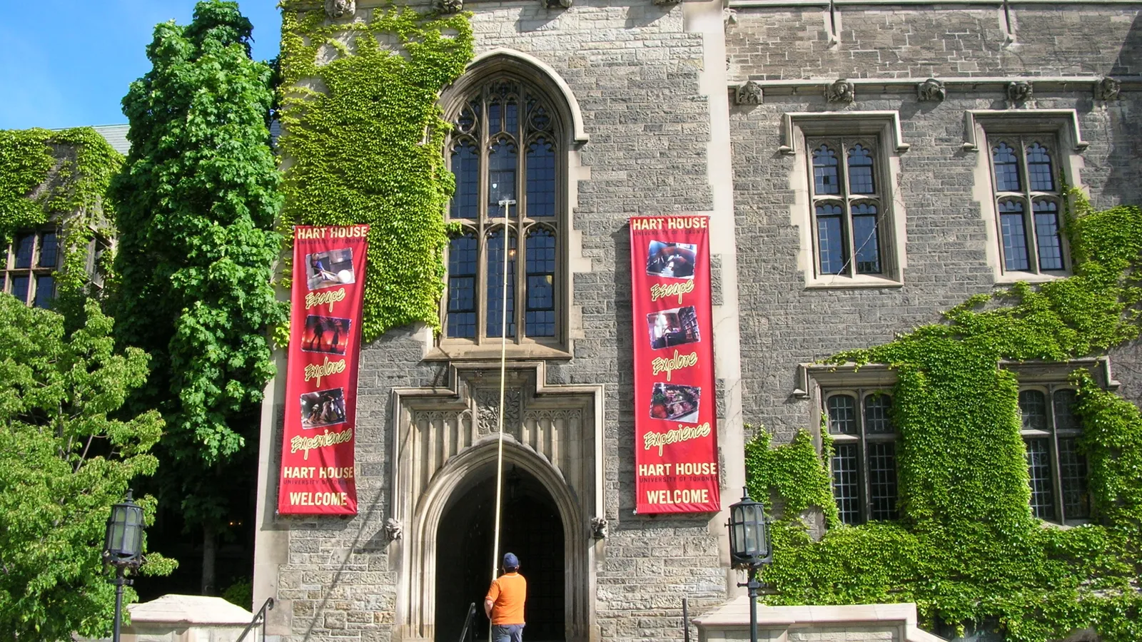 Hart House with ivy-covered walls under clear sky