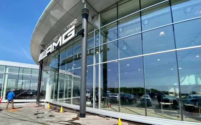 Windows being cleaned at a car dealership