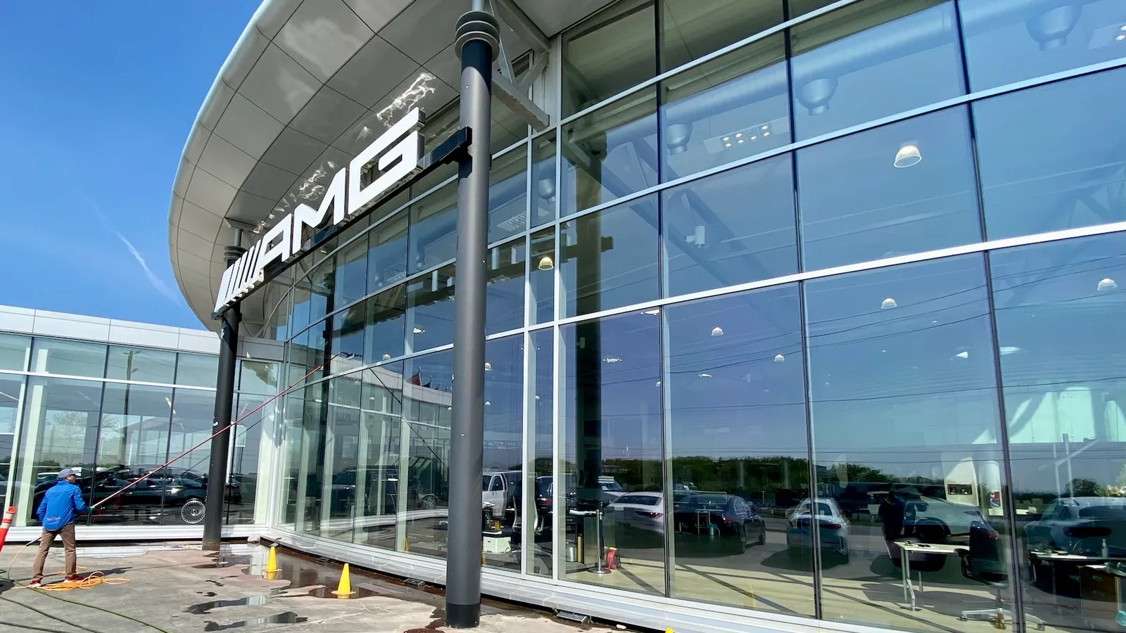 Windows being cleaned at a car dealership