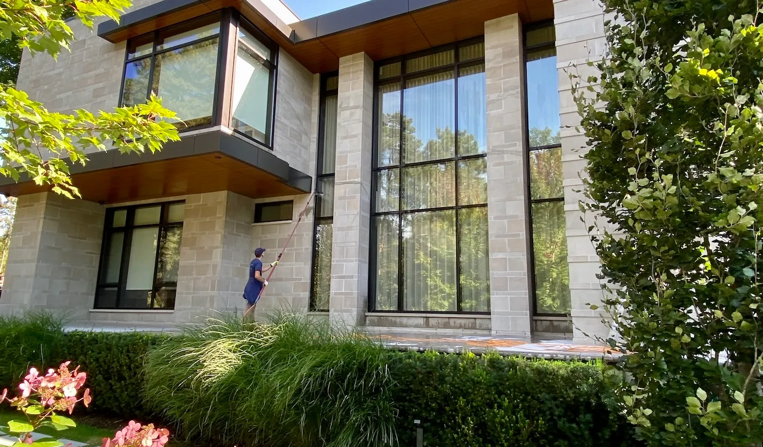 Cleaning the windows of a nice house
