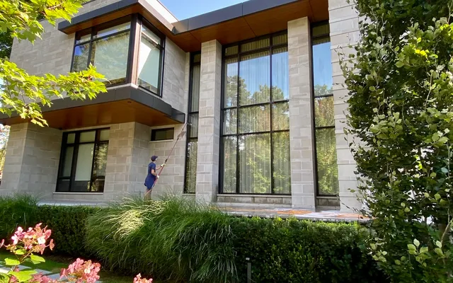 Cleaning the windows of a nice house