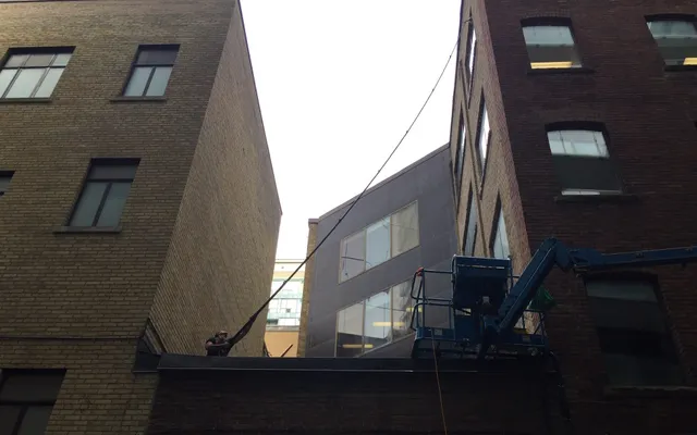 A window cleaner busy cleaning a commercial building