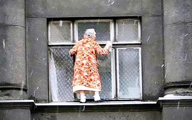 Should I clean my own windows? A old lady in a very scary way cleaning a window.