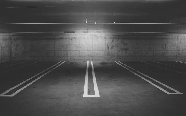 Empty underground parking lot with concrete walls