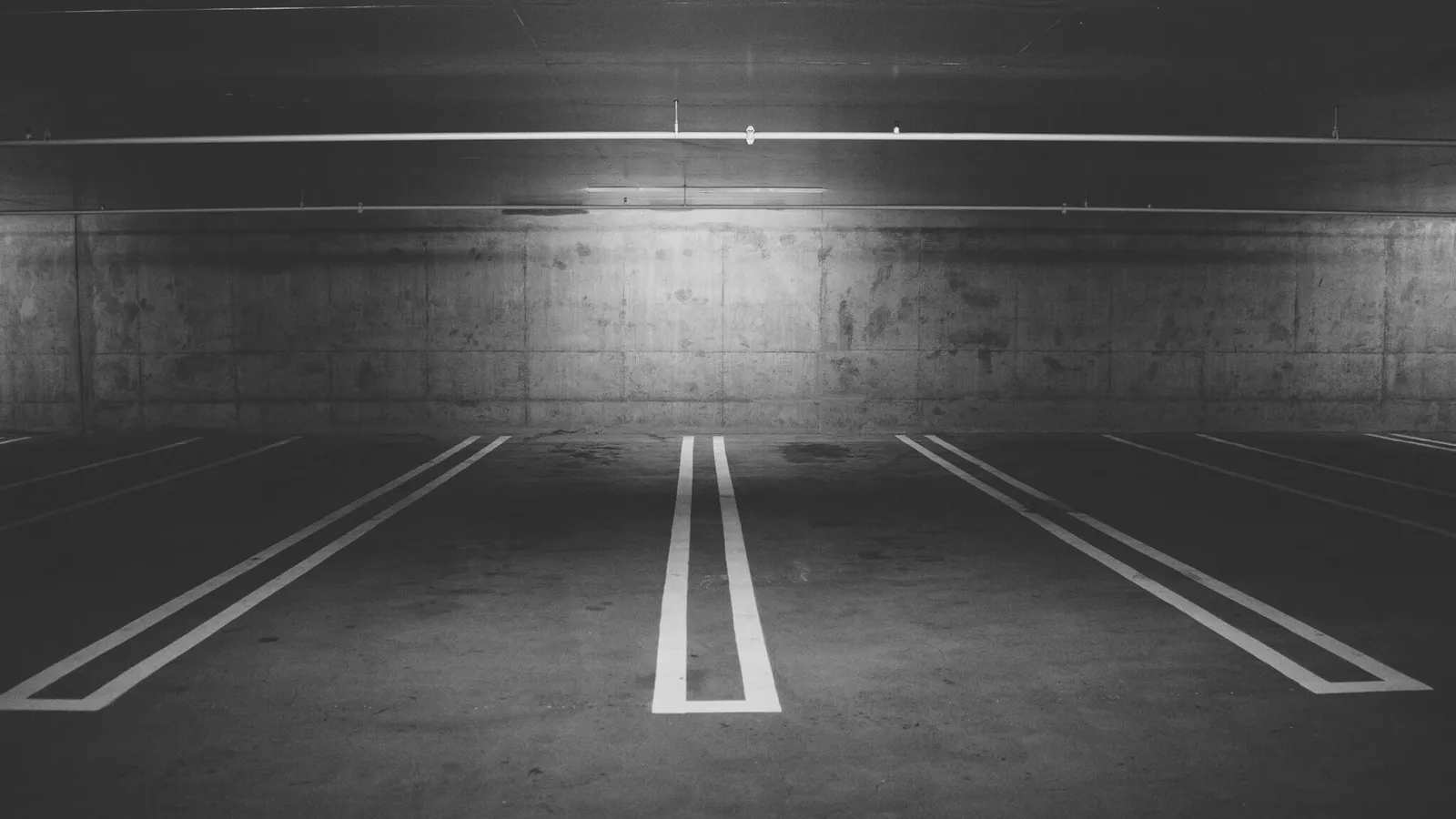 Empty underground parking lot with concrete walls