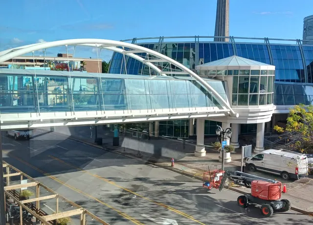 Modern pedestrian bridge over city street and construction. Before and after window clean