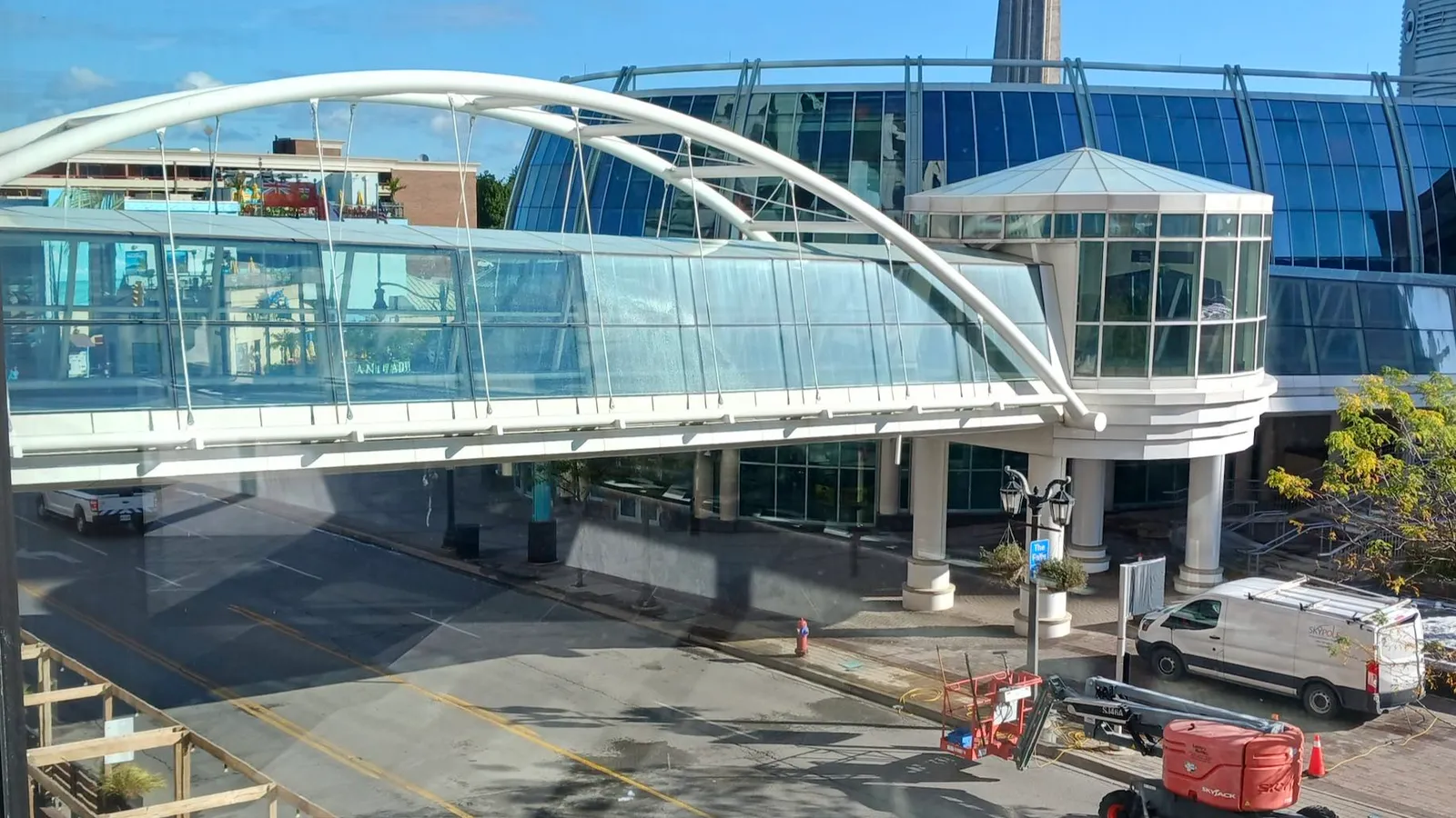 Modern pedestrian bridge over city street and construction. Before and after window clean