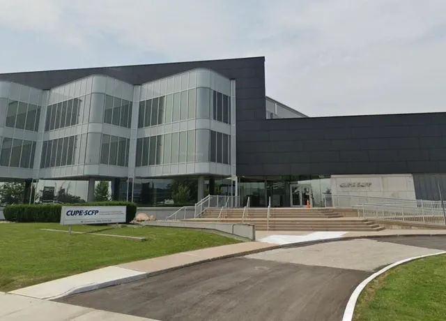 Modern corporate building with glass facade and landscaping