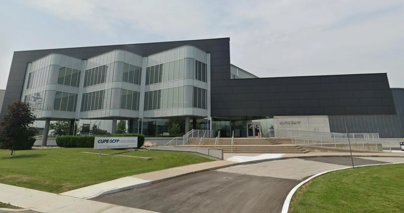Modern corporate building with glass facade and landscaping
