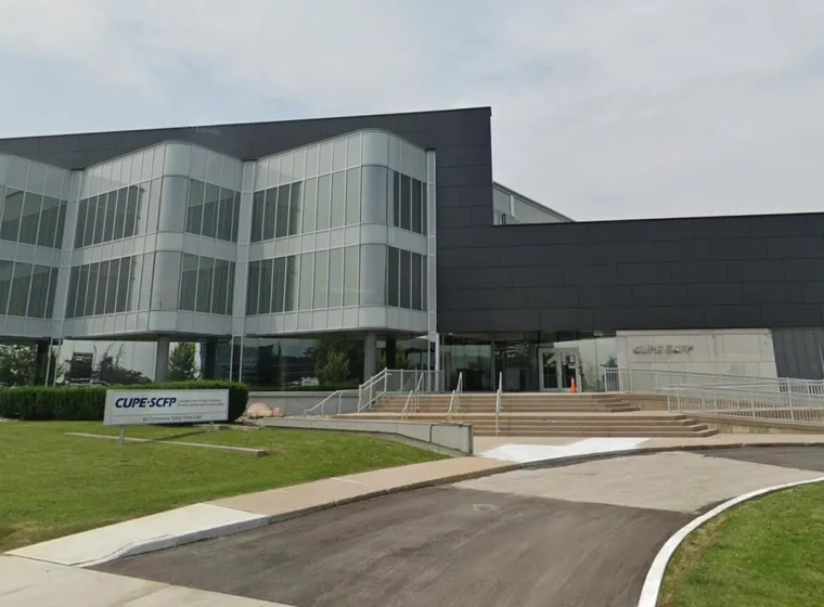 Modern corporate building with glass facade and landscaping