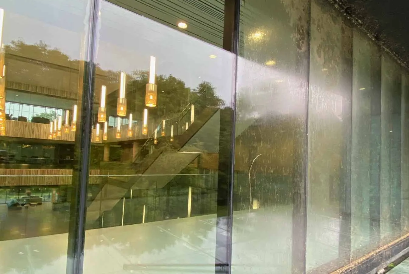 Professional commercial window cleaning in Toronto by SKYPOLE on a modern business building with reflective glass windows and clear blue skies.