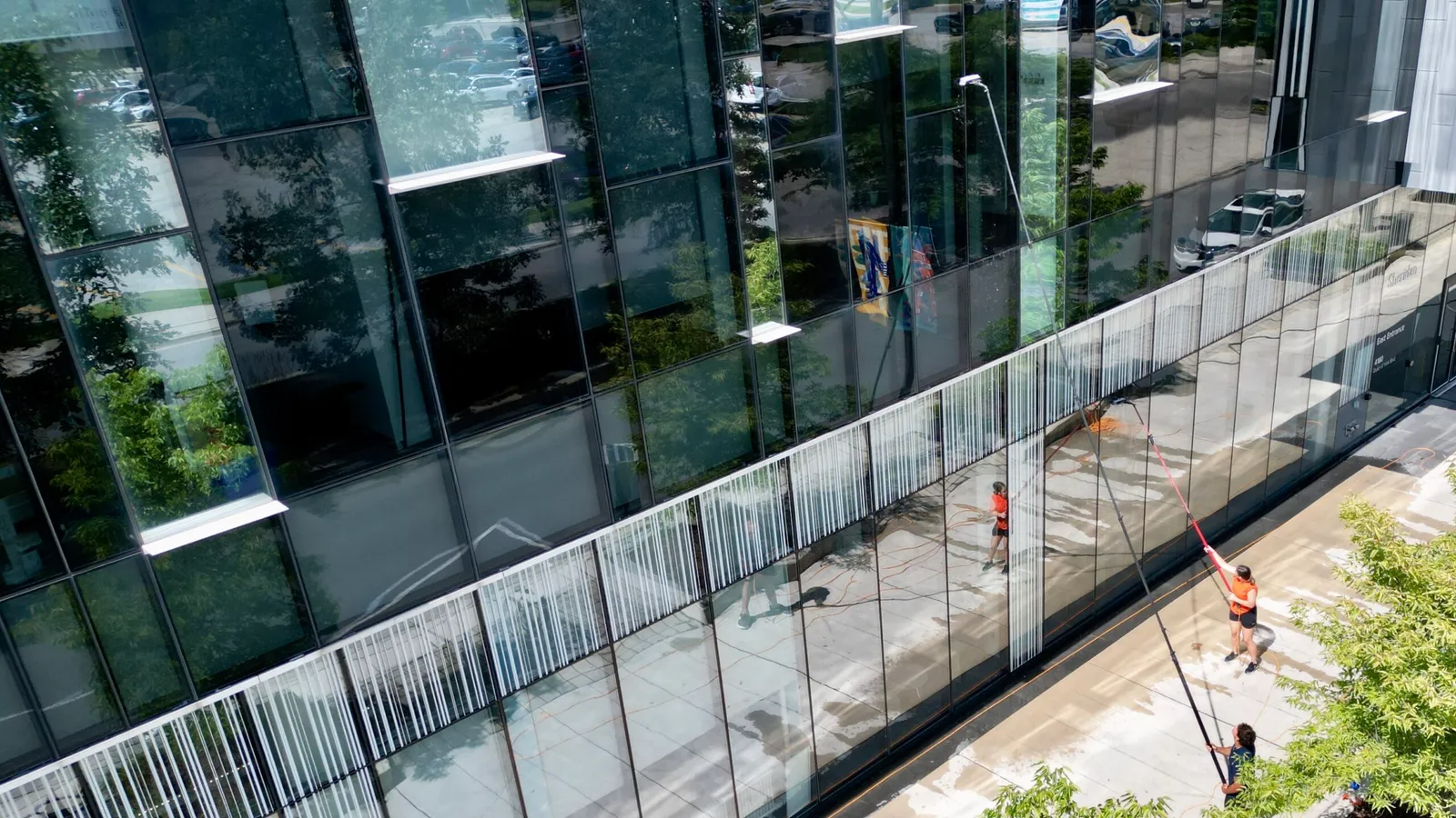 Two SKYPOLE window cleaners keeping a commercial property looking great.