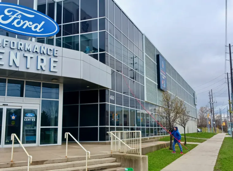 Ford Performance Centre exterior with signage and passerby.