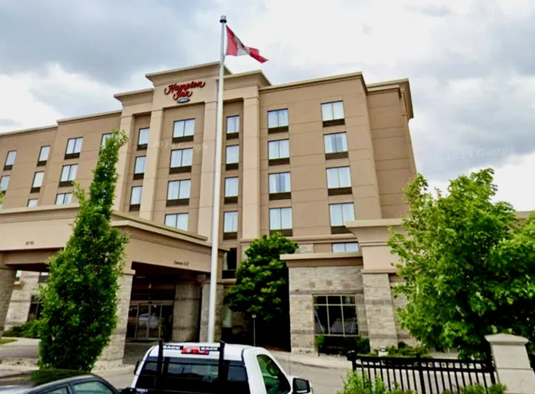 Hampton Inn hotel exterior with Canadian flag in Brampton