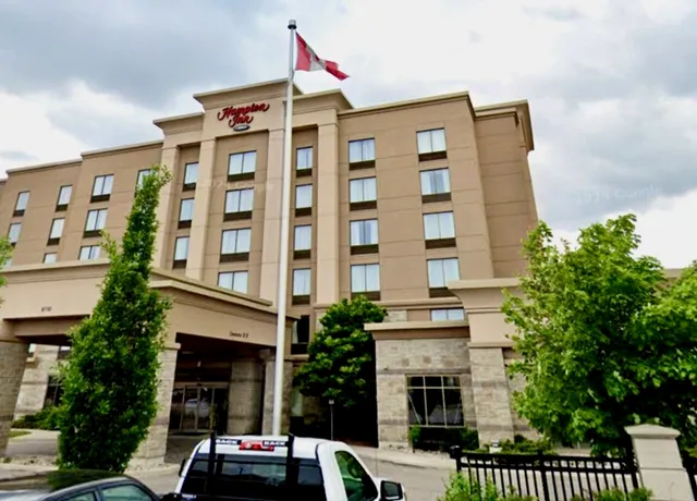 Hampton Inn hotel exterior with Canadian flag in Brampton