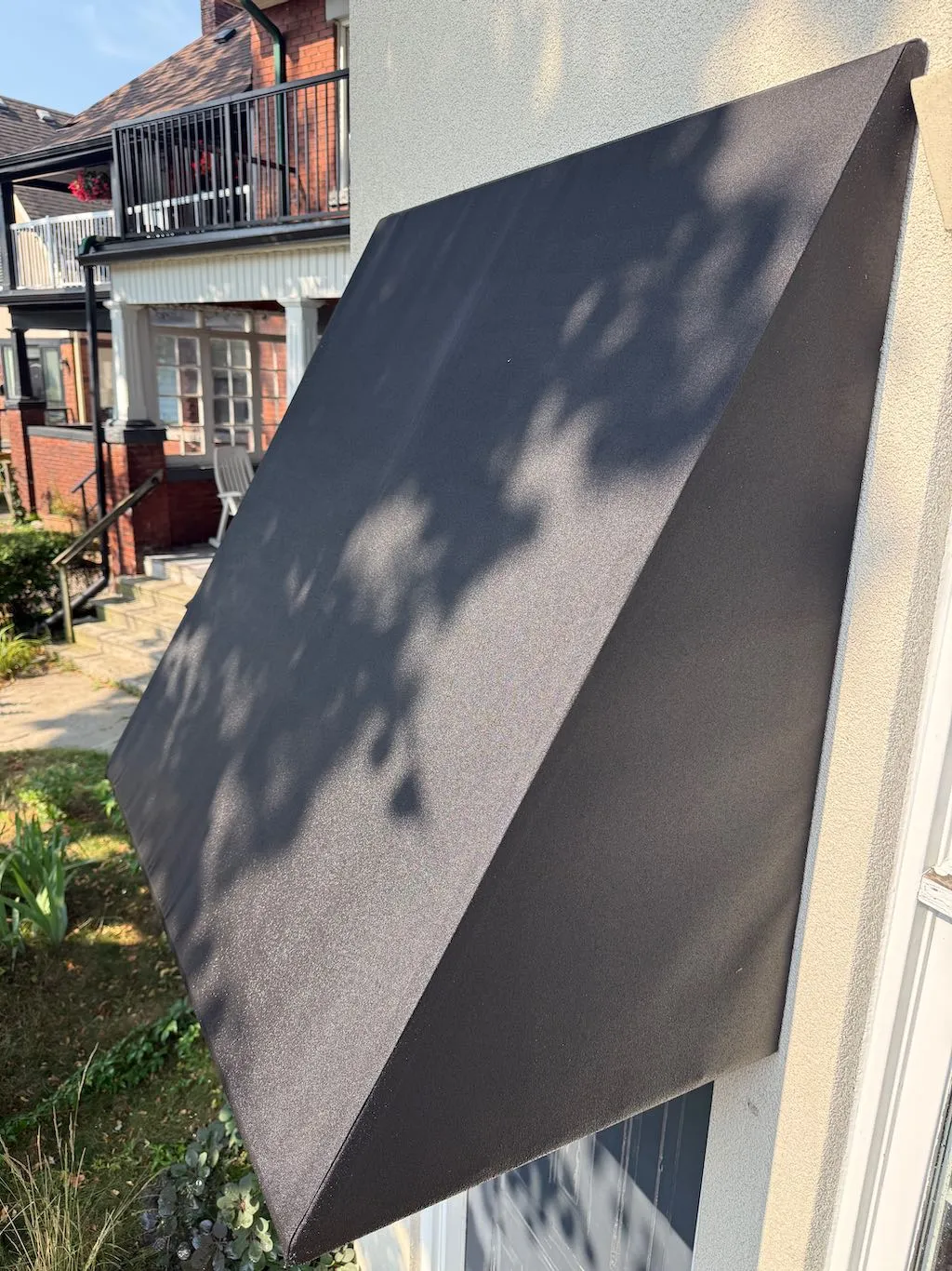 Black awning that has been freshly cleaned