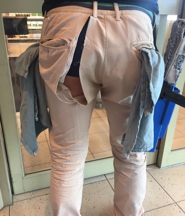 Person with torn pants revealing underwear standing