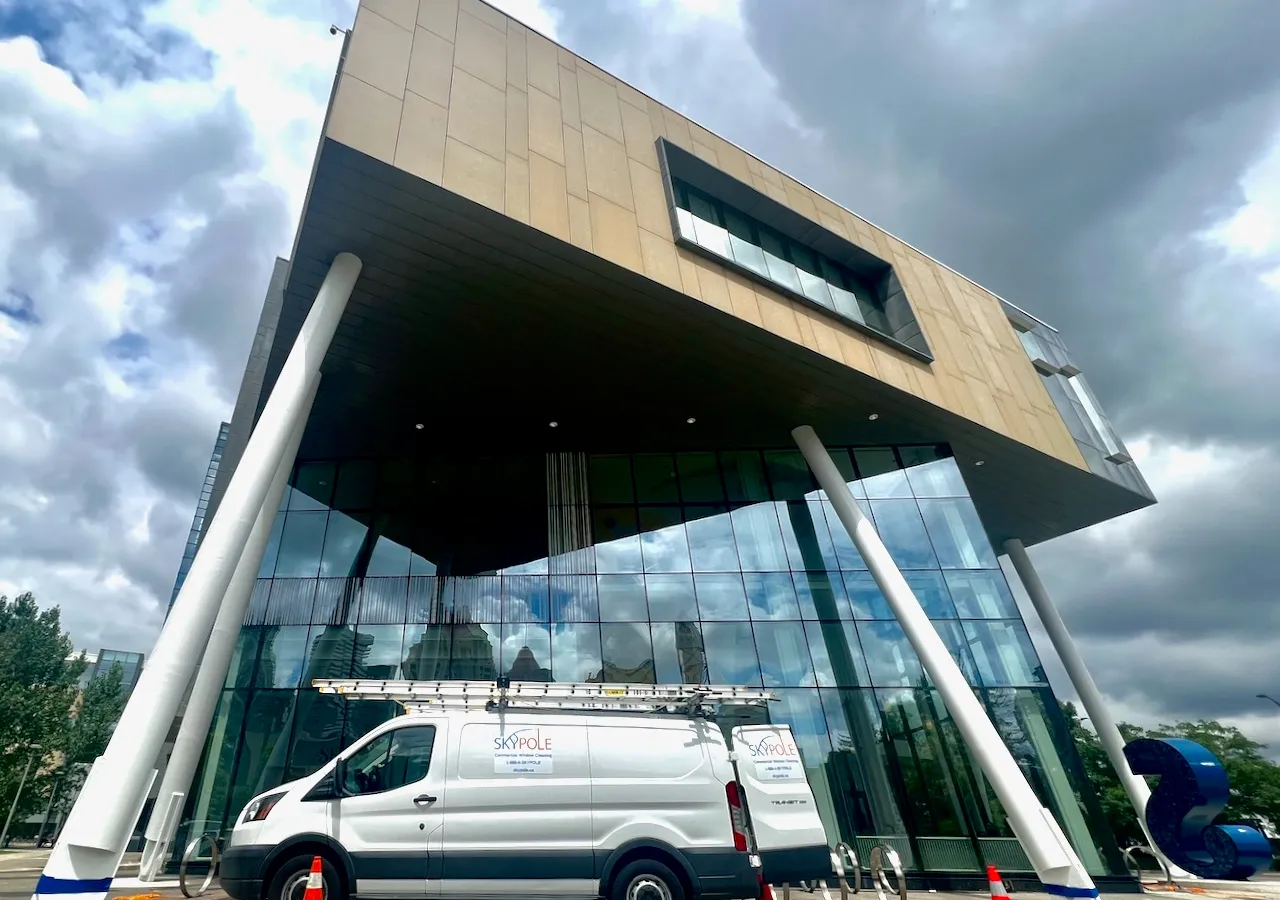 Modern building facade with white van parked in front in Mississauga