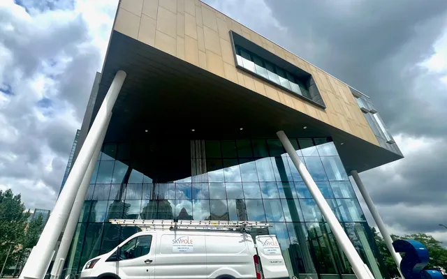 Modern building facade with white van parked in front in Mississauga