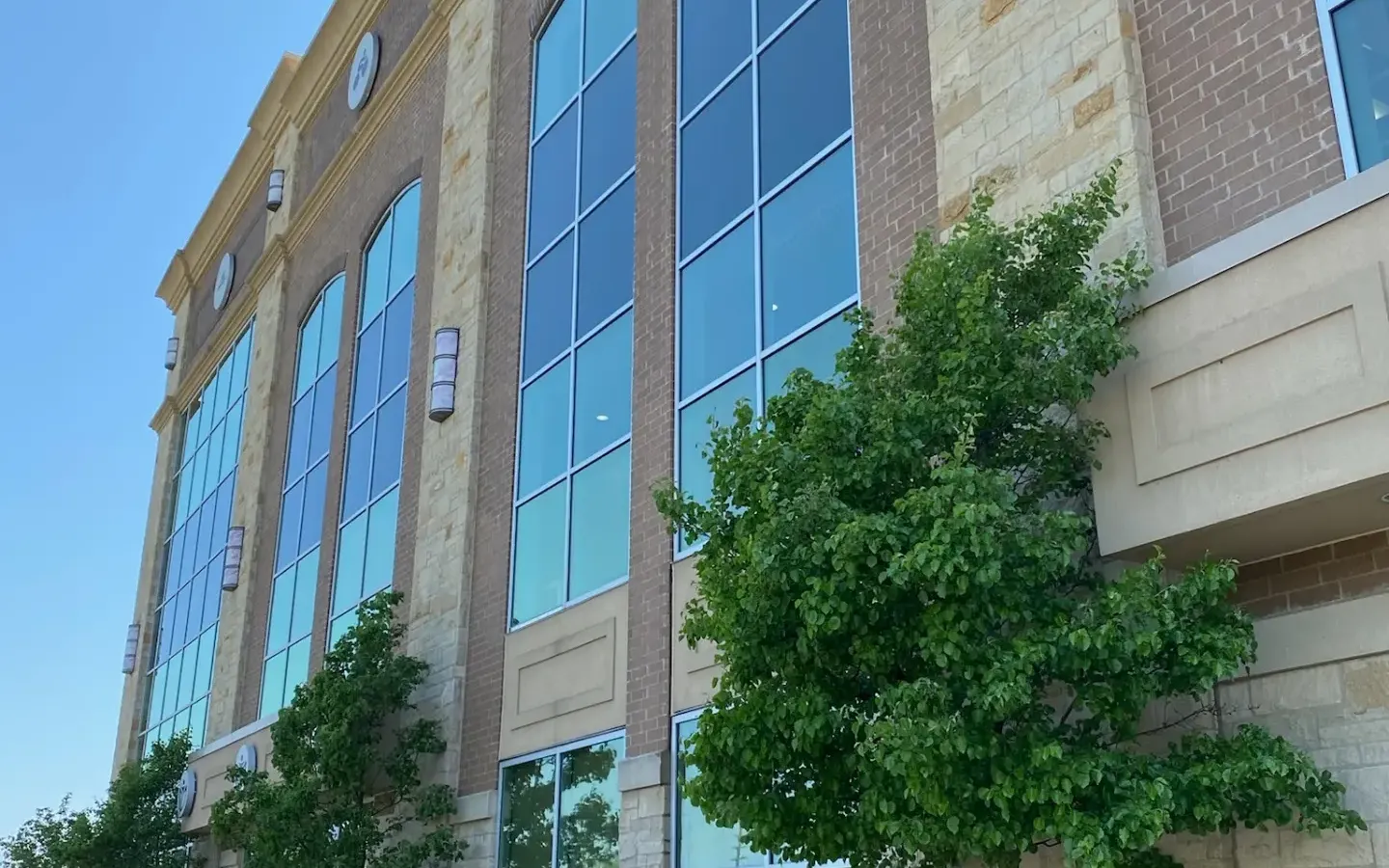 Person power-washing Lifetime Fitness entrance.