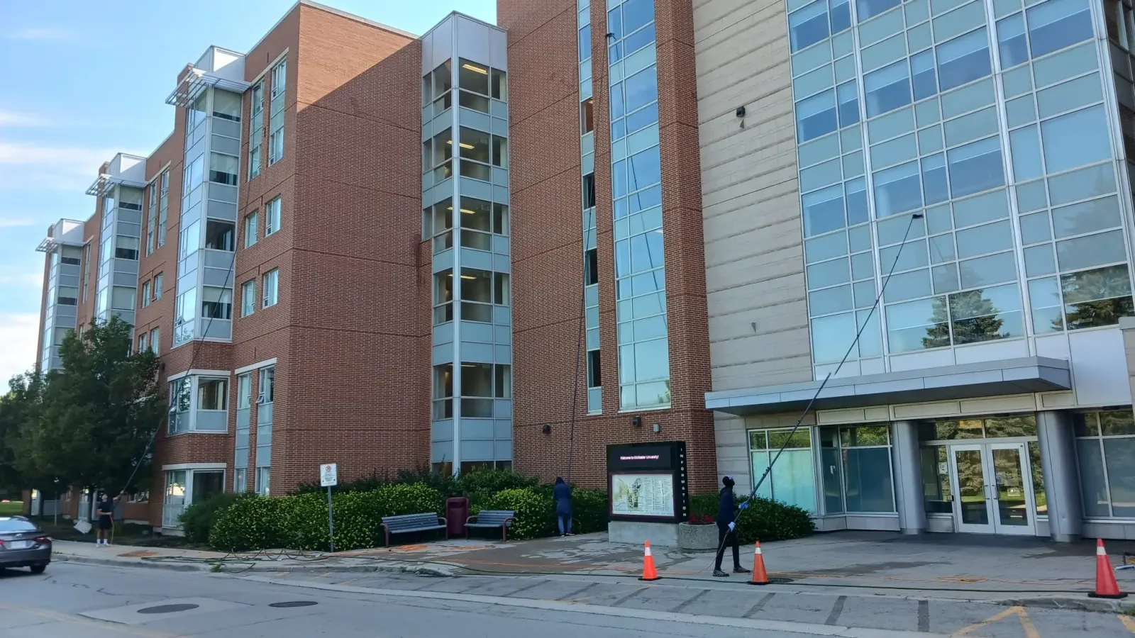 Wide view of Skypole cleaning upper-storey windows at McMaster University’s Mary E. Keyes Residence.
