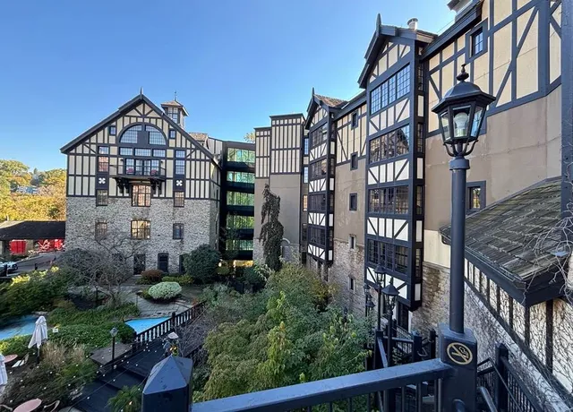 Tudor style hotel with lush garden and iron lamps