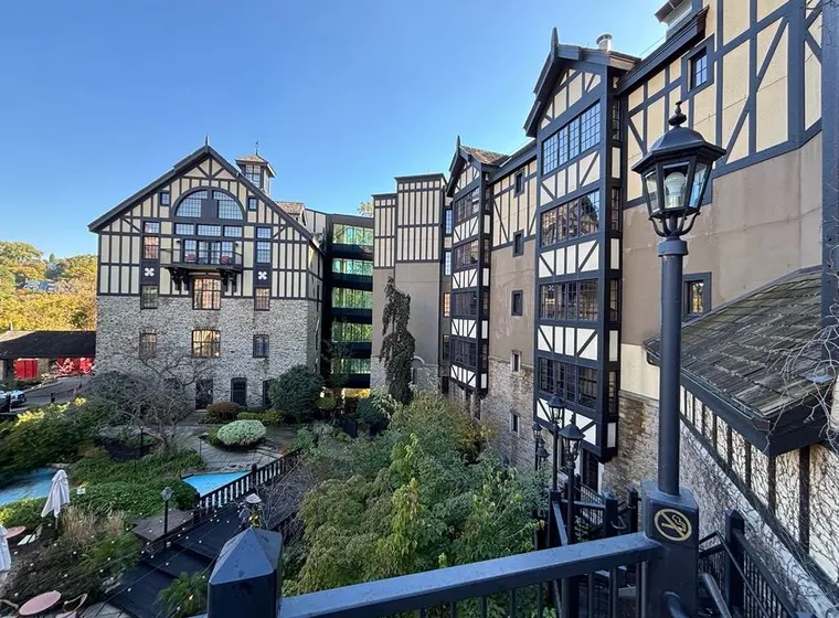 Tudor style hotel with lush garden and iron lamps