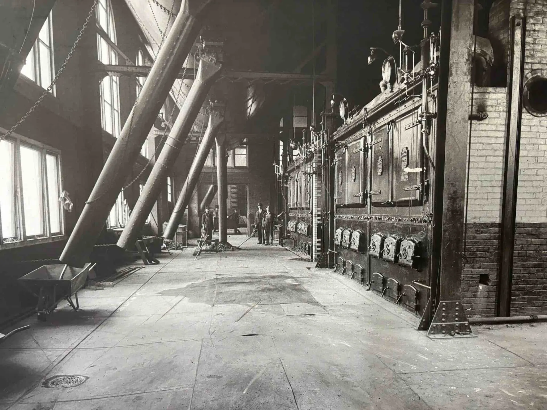 Vintage industrial interior with large pipes and machinery.