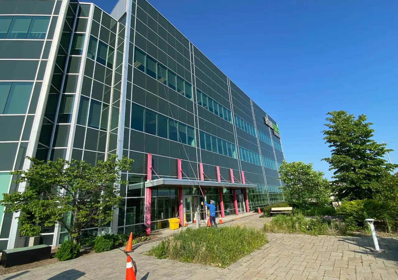 Modern corporate building with colorful accents and green landscaping.