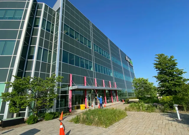 Modern corporate building with colorful accents and green landscaping.