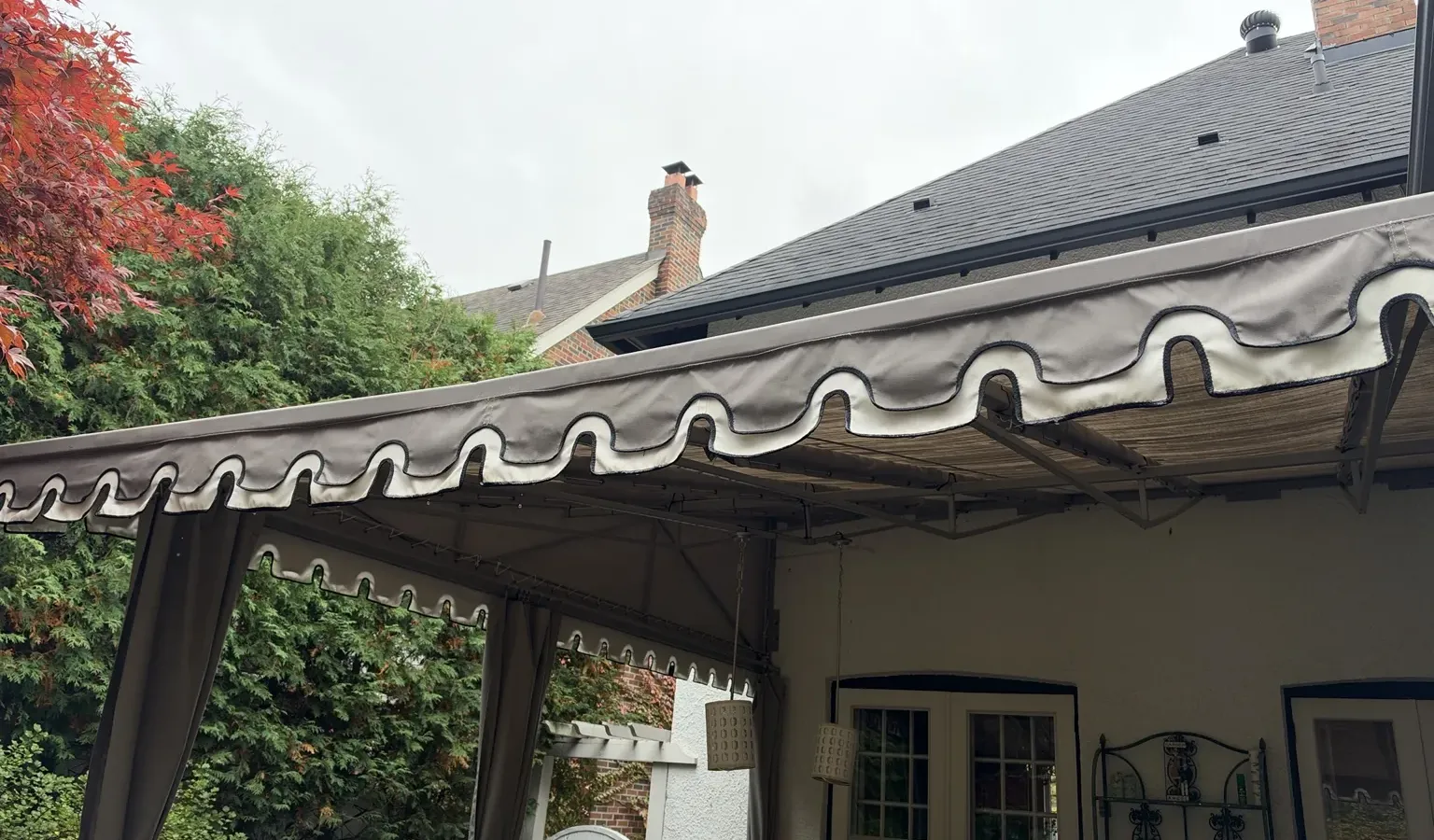 Large residential patio awning with decorative fabric valance at a home in Rosedale, Toronto, professionally cleaned by SKYPOLE Inc.