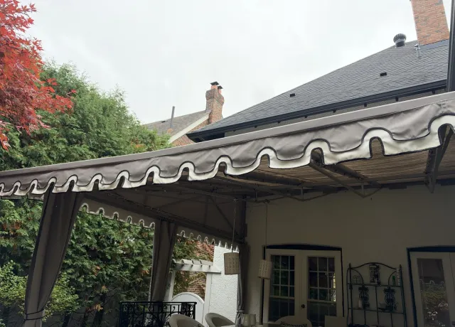 Large residential patio awning with decorative fabric valance at a home in Rosedale, Toronto, professionally cleaned by SKYPOLE Inc.