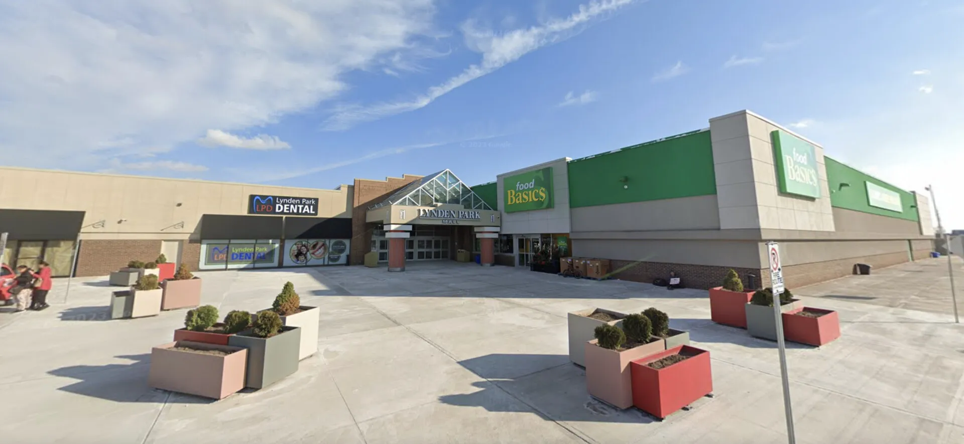 Suburban mall entrance with dental and grocery stores