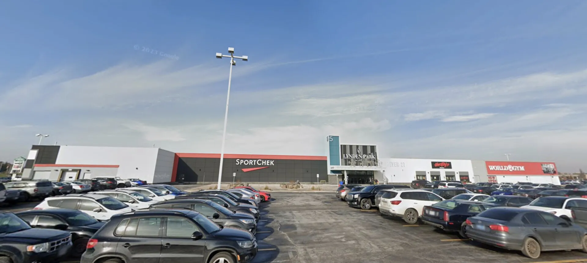 Crowded parking lot in front of Sport Chek and other stores