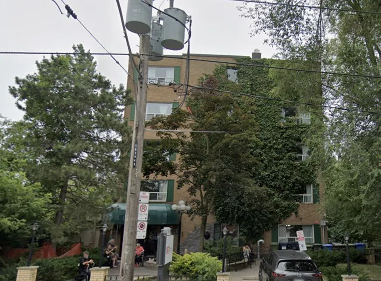 Urban street scene with apartment building and parked cars