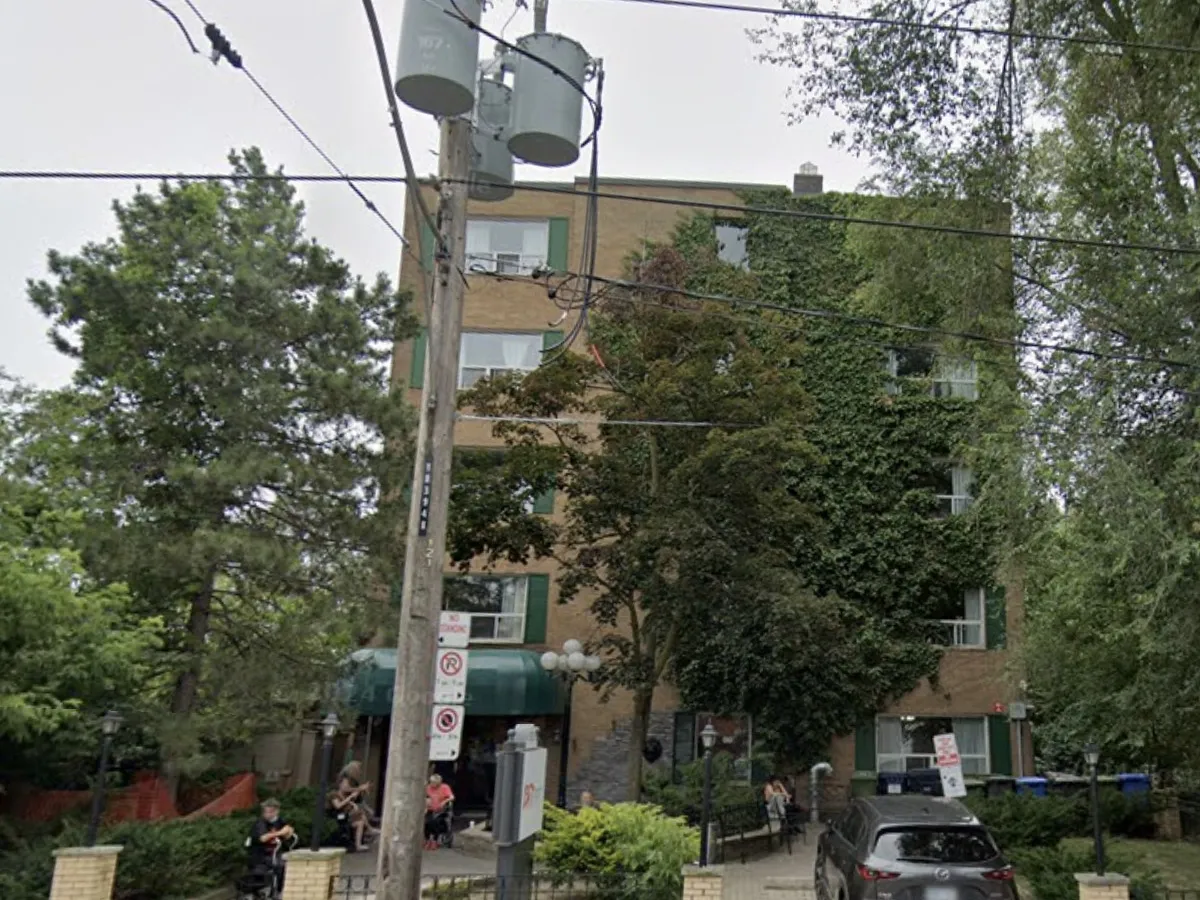 Urban street scene with apartment building and parked cars
