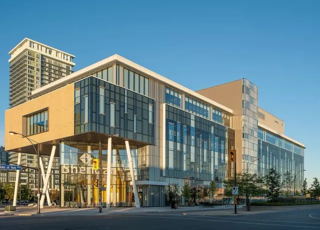 Modern glass building at intersection during daylight, Sheridan Mississauga