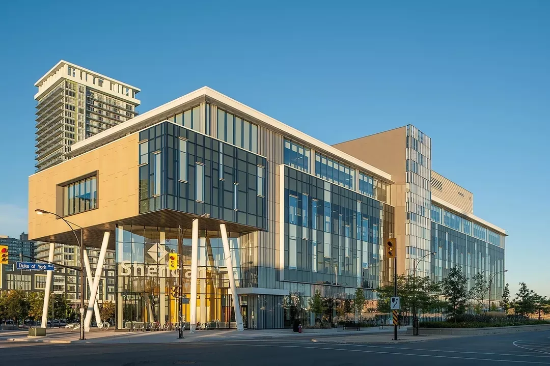 Modern glass building at intersection during daylight, Sheridan Mississauga