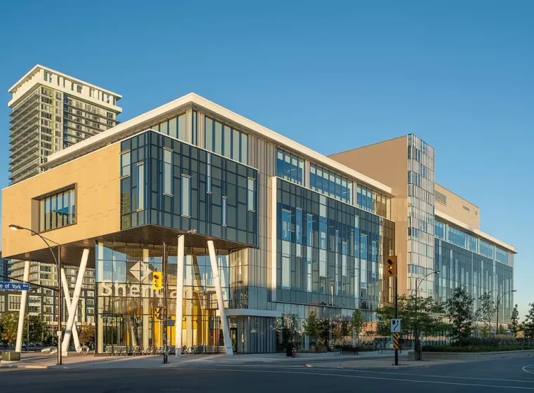 Modern glass building at intersection during daylight, Sheridan Mississauga