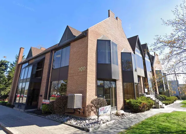 Modern brick office building with large windows and lawn