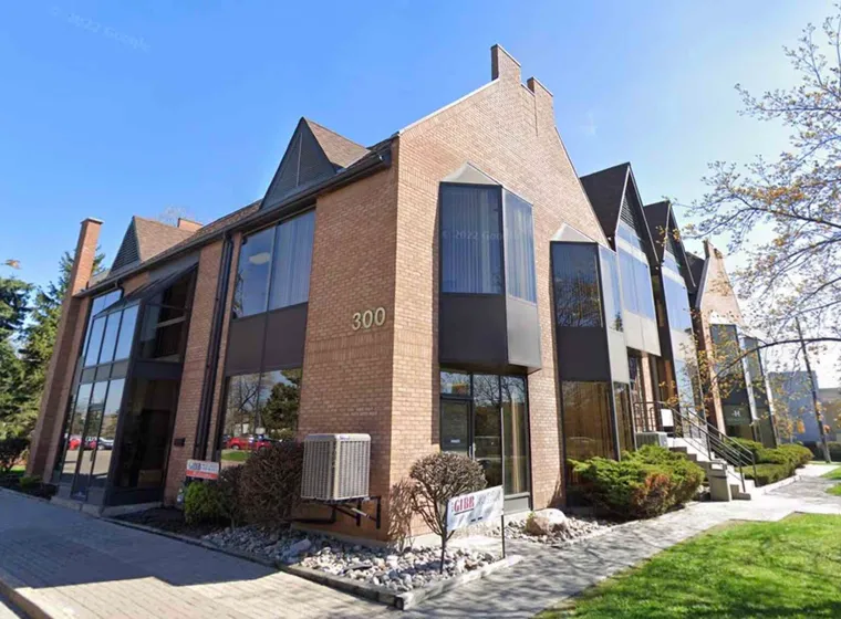 Modern brick office building with large windows and lawn