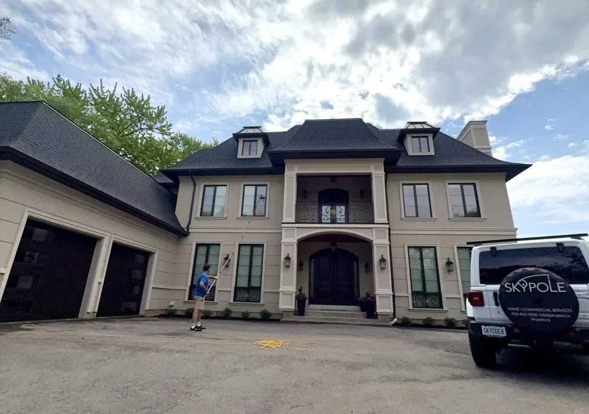 Front elevation of a luxury estate home receiving professional exterior window cleaning services by SKYPOLE.