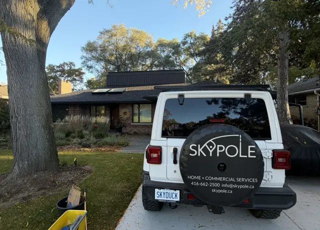 SKYPOLE Window Cleaning vehicle parked outside an Etobicoke home during residential exterior window, skylight and eavestrough cleaning.