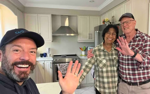 Three people smiling in a bright kitchen in Brampton