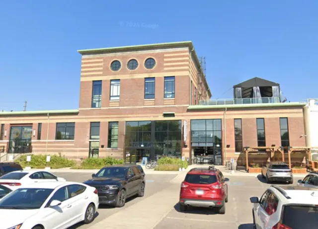Exterior window cleaning at commercial building on Symes Road in Toronto using water-fed pole system by Skypole Window Cleaning