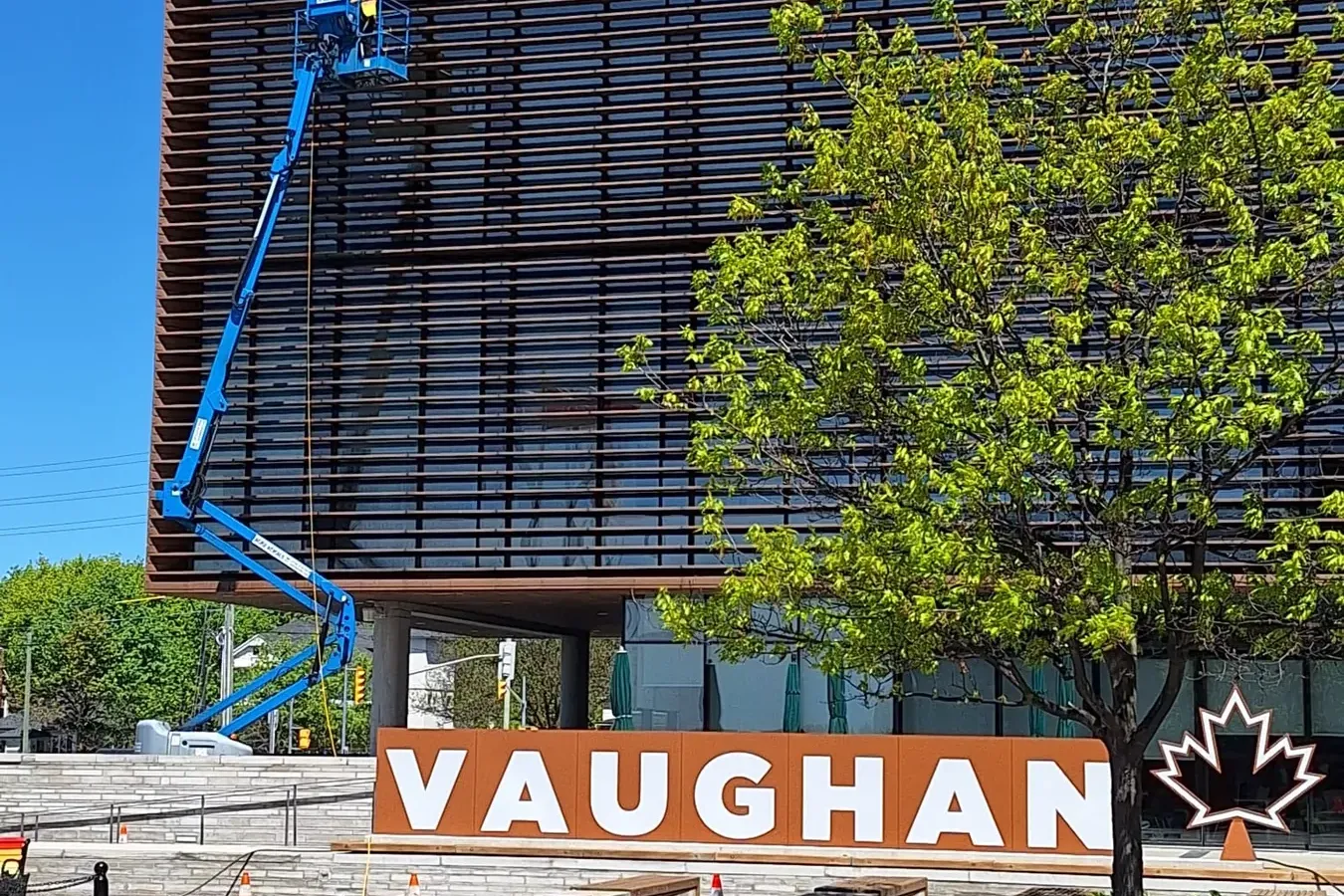 SKYPOLE safely cleaning the exterior façade of Vaughan City Hall using a boom lift and controlled work zone.