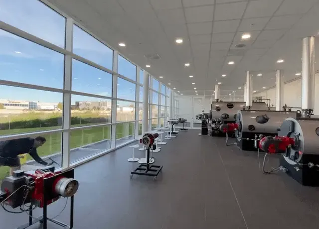 Industrial laboratory with equipment and large windows.