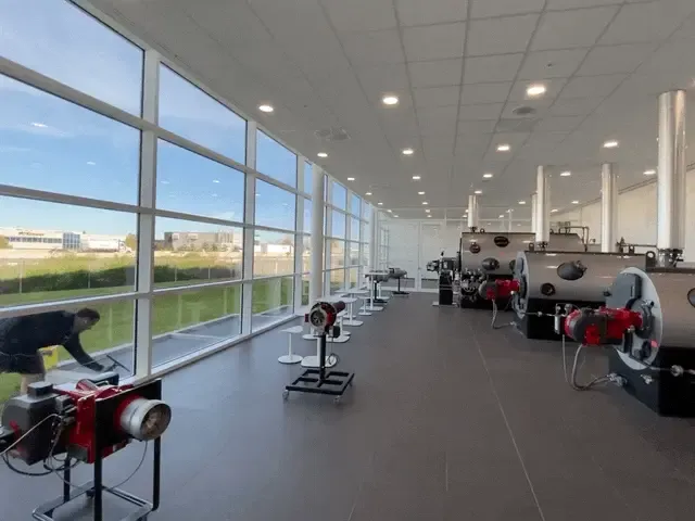 Industrial laboratory with equipment and large windows.