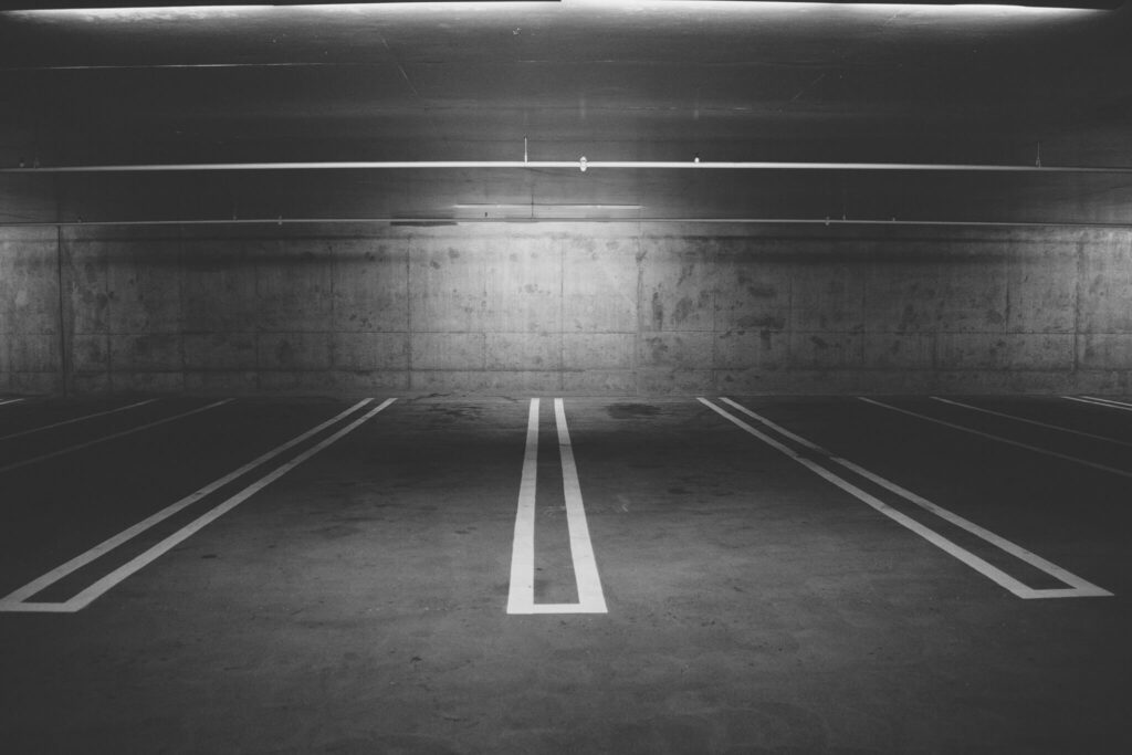 Empty underground parking lot with concrete walls