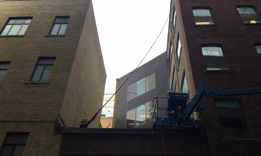 A window cleaner busy cleaning a commercial building